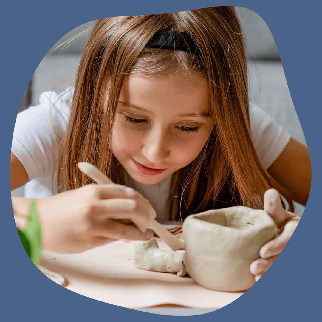 Child hand-carving Sculpd Kids Pottery Kit clay with a wooden tool