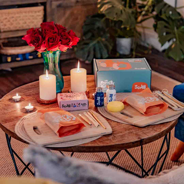 Sculpd Pottery Kit laid out on table with candle and roses