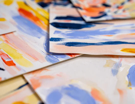 Several paintings scattered on a table  made using Sculpd Canvas Painting Kit