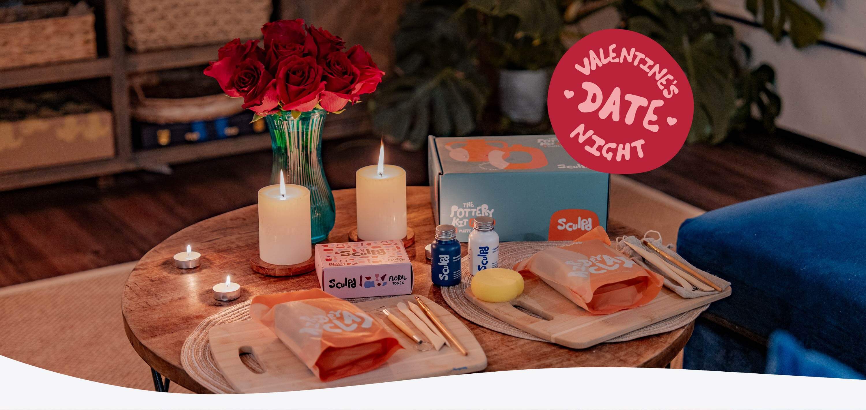 Sculpd Pottery Kit laid out on a table with roses and candles 